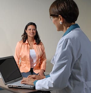 Person in exam room talking to doctor.